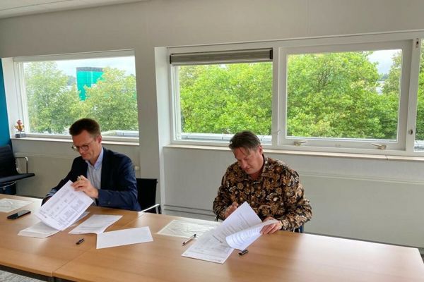 Twee mannen ondertekenen papieren