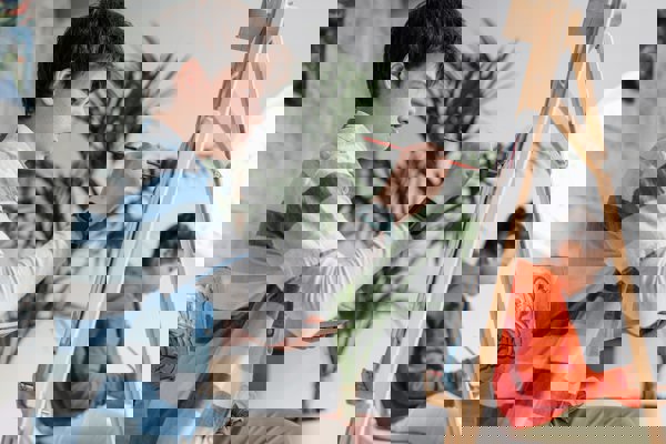 Kind schildert achter een schildersezel