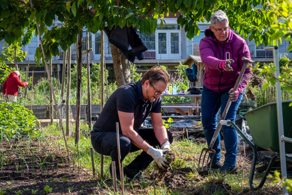 Twee collega's Intermaris werken in een moestuin